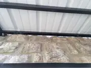 Custom metal awning frame fabrication with welded supports.