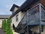 Black metal deck staircase installation viewed from the landing.