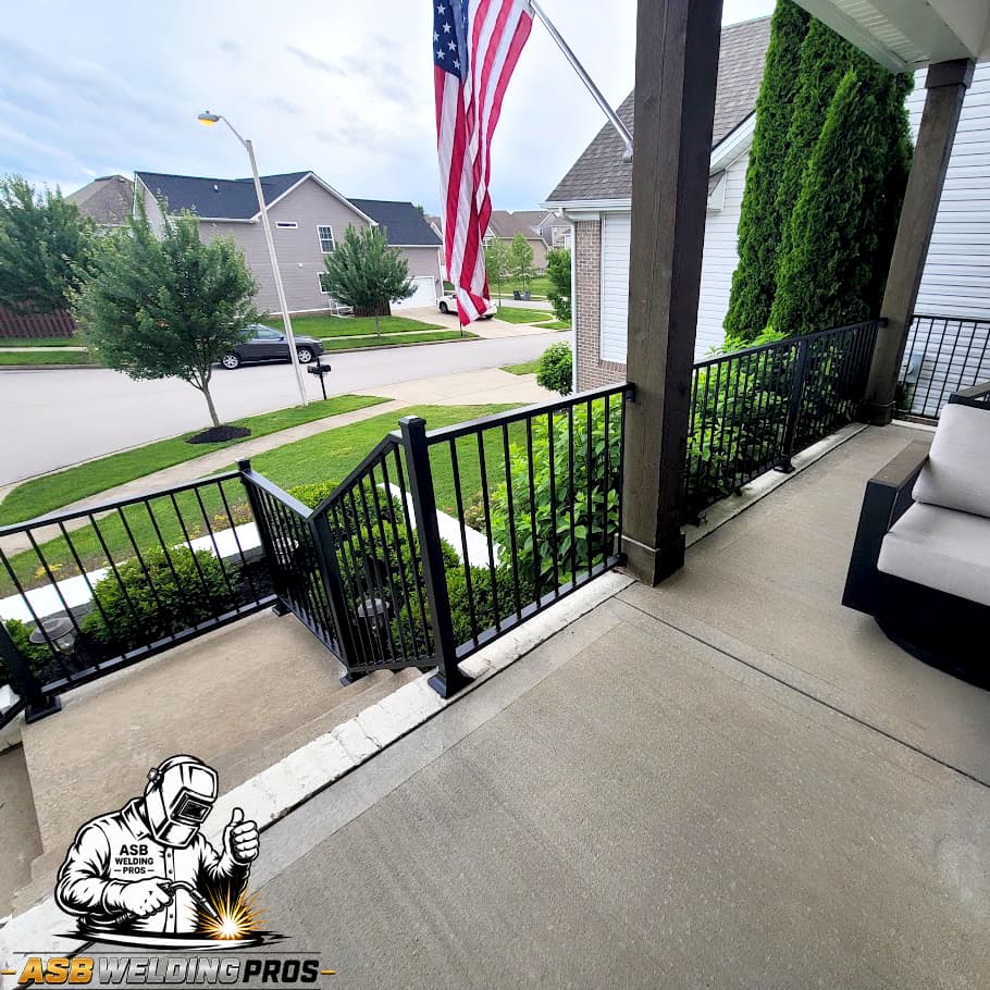 Black metal porch and access railing installed across a residential entry.