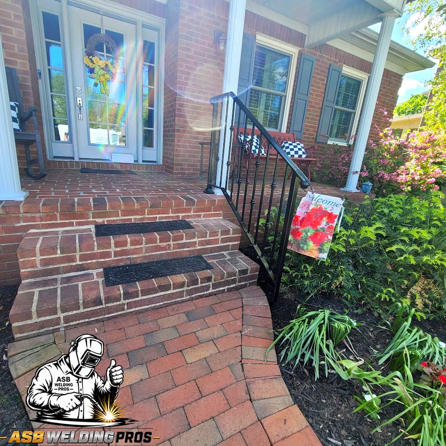 Black metal railing installed along brick front steps.
