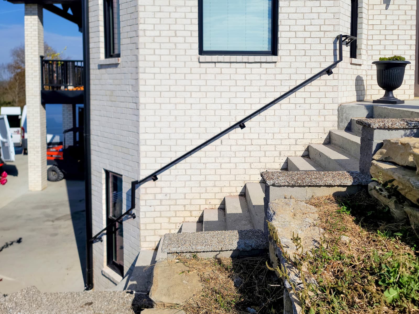 Exterior metal stair railing installed for safe access.