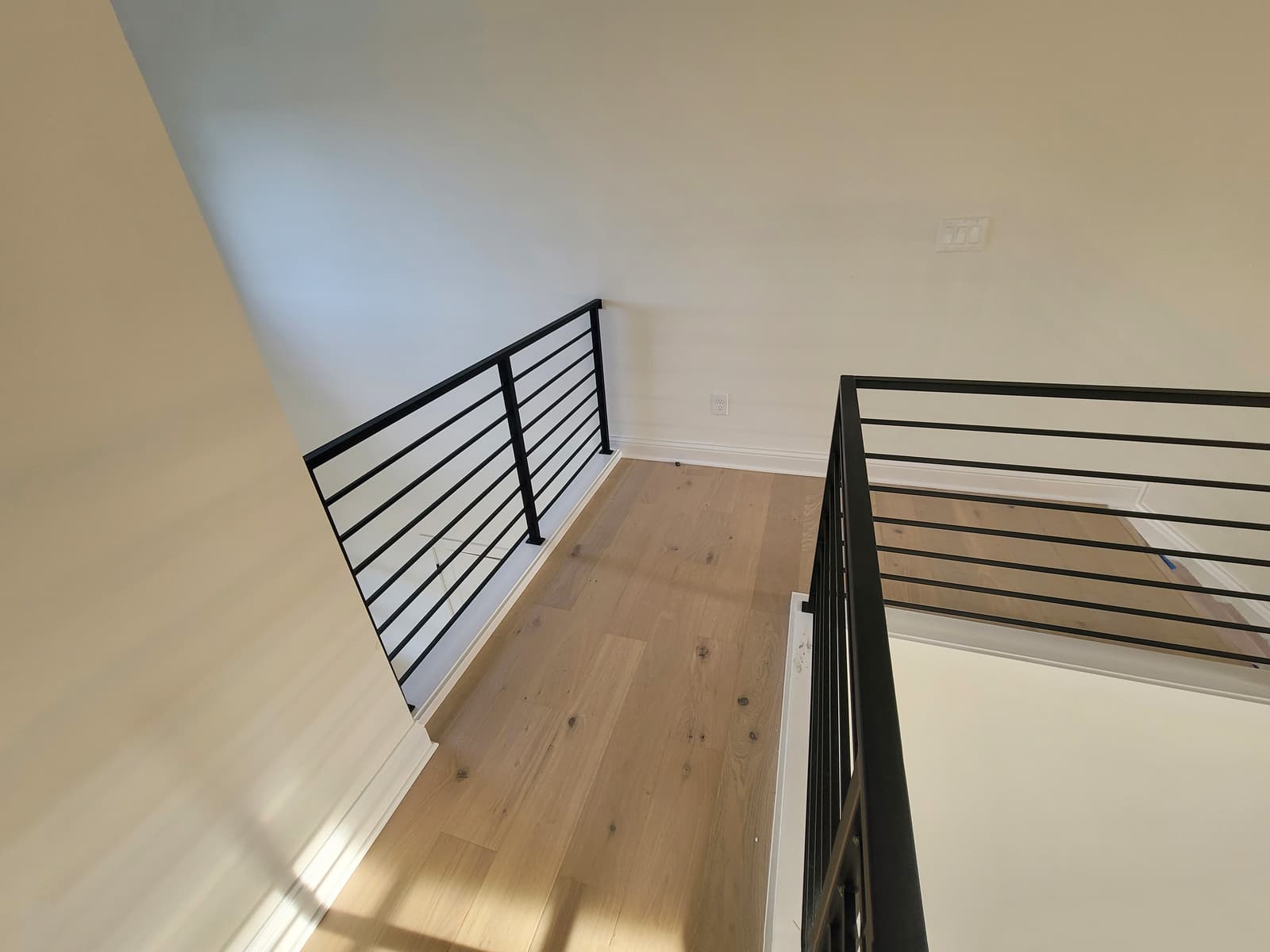 Modern metal stair railing with horizontal rail details.