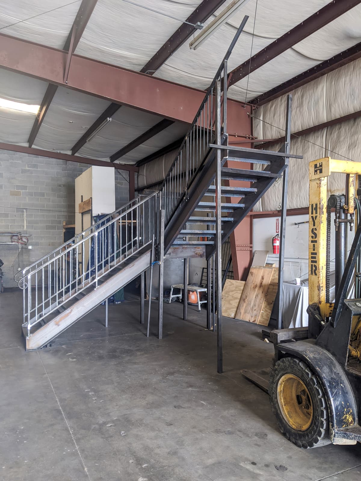 Deck metal staircase construction with welded stringer details.