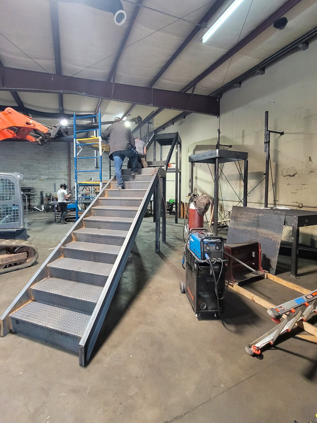 Commercial metal fire escape staircase with guardrail work.
