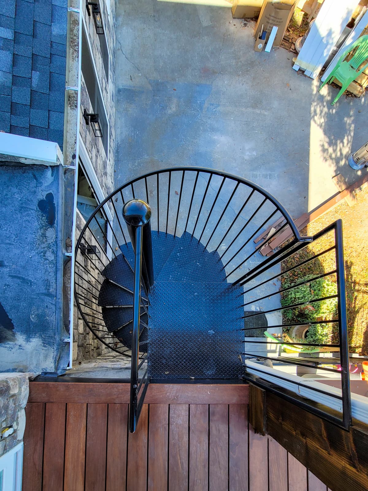 Metal spiral staircase with curved railing in progress