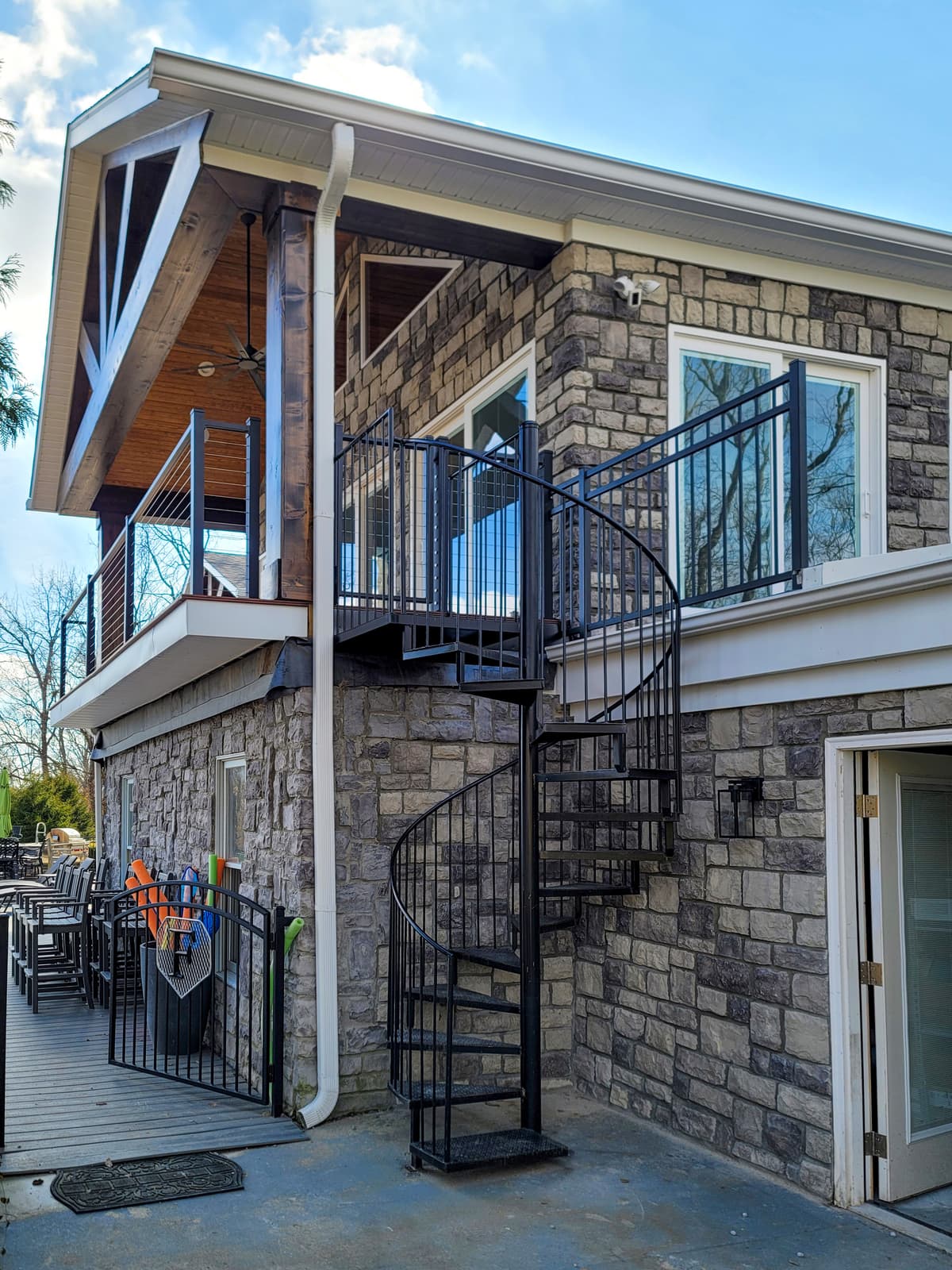 Curved railing and tread assembly on a custom spiral metal staircase.